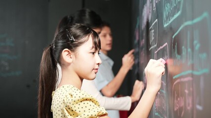 Multicultural smart student writing engineering code with site view. Diverse children planning creative idea or coding system. Cute asian girl using blackboard to explain develop plan. Edification