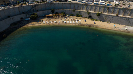 Aerial view of the town beach of Castellammare del Golfo, located in the province of Trapani, Sicily, Italy. The small cove is located just below the historic centre, separated only by a high wall.