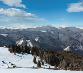 Winter snowy mountains, and lone farmstead