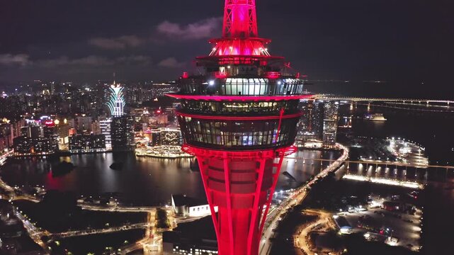 Aerial view of tower and downtown skyline at night, Macao, China