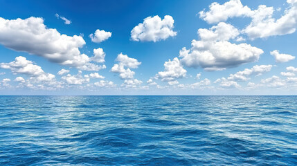 Obraz premium Vast ocean under bright blue sky filled with fluffy white clouds creates serene atmosphere