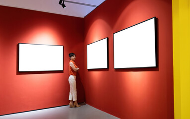 Woman standing and looking blank pictures