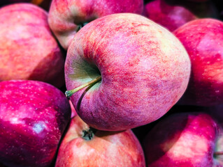vibrant, deep red apples in dramatic close-up at market display
