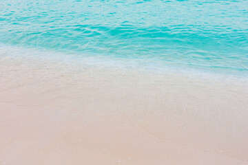 The ocean is calm and the water is a beautiful shade of blue