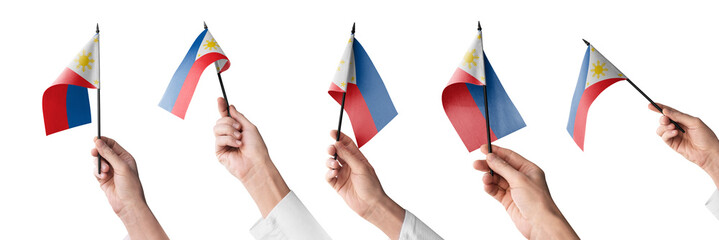 The Philippines flag in hand in different angles on a white background © butenkow
