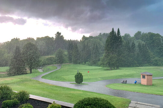 Rain delay on a green golf course and dark cloudy stormy skies on a summer day in Canada - Powered by Adobe