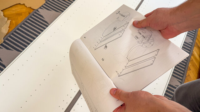 Assembly metamorphosis unfolds in hands of Caucasian male, echoing DIY sanctuaries and National Home Improvement Month creativity