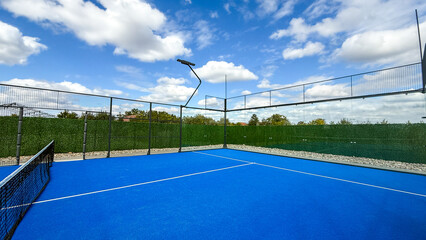 Bright azure padel court under whimsical clouds, daydreams of Wimbledon afternoons and...