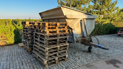 Sunlit rustic pallets beside a vintage trailer, evoking Harvest Festival vibes and echoing Recycle...