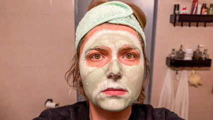 An enigmatic Caucasian woman with a whimsical seafoam mask exudes tranquility amidst Bathroom...