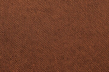 Fototapeta premium Detailed close-up of brown denim fabric texture with diagonal weave pattern. Ideal textile for clothing, upholstery, and decorative purposes.