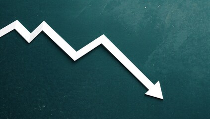 Real estate market downturn depicted by declining arrow on graph, illustrating housing price collapse during economic crisis.