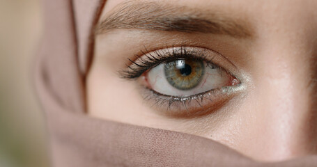 Close up half face of woman in brown hijab with closed eyes emotional minimal portrait symbol of...