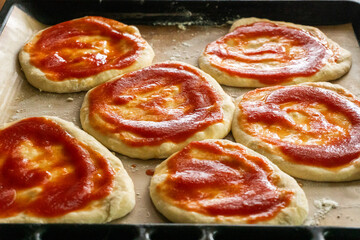 Homemade mini pizzas with sausages. Pastries. Bread. Dough.