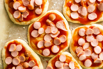 Homemade mini pizzas with sausages. Pastries. Bread. Dough.