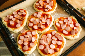 Homemade mini pizzas with sausages. Pastries. Bread. Dough.