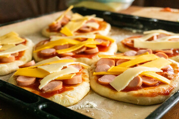 Homemade mini pizzas with sausages. Pastries. Bread. Dough.