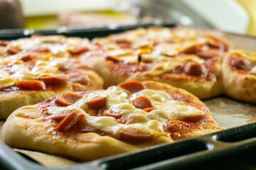 Homemade mini pizzas with sausages. Pastries. Bread. Dough.