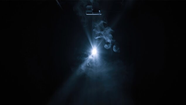 Beam from a projector illuminating a dark space