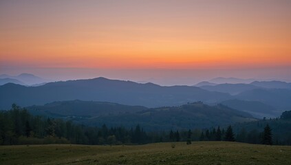 Obraz premium Silhouetted peaks emerging from vibrant morning mist in a serene mountain scene.