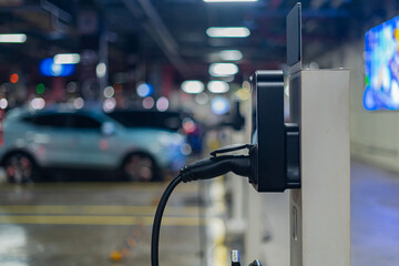 Electric vehicle charging plug at electric vehicle charging station
