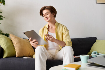 Young fashionable man enjoying a tablet in a cozy living room