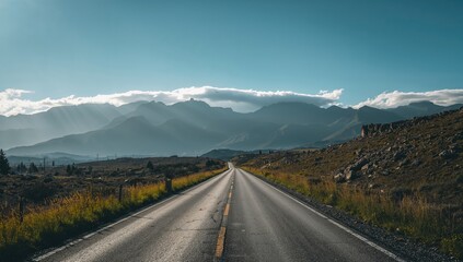Naklejka premium Empty asphalt highway from the side with cloudy hills under a bright sunny sky.
