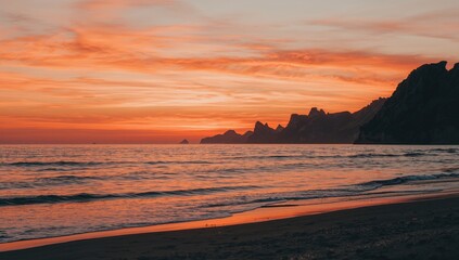 Fototapeta premium Sunset with mountain outlines and a warm, romantic sky