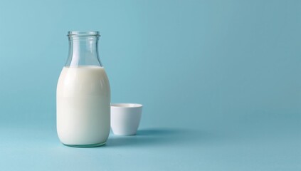 Pitcher of milk against a blue backdrop. Theme of fresh dairy goods, milk consumption, and celebration. Empty space available.