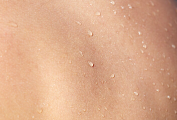 Fototapeta premium A person's back is wet with water