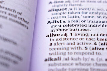 Fototapeta premium Close Up Of English Dictionary Page With Word - alive