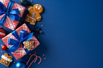 A festive arrangement of wrapped gifts with blue ribbons, gingerbread man, cookies, and candy canes...