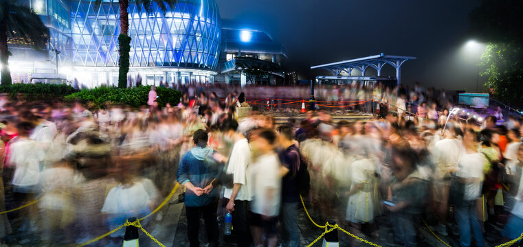 Blur of crowd people queuing up and waiting