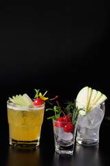 Refreshing summer cocktails on a table, with garnish, ice, and creative arrangements