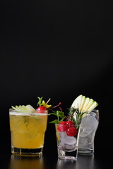 Three elegant cocktails, perfect for any occasion, presented against a dark backdrop