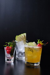 A refreshing collection of three expertly crafted cocktails, each garnished to perfection, ready to tantalize taste buds. The play of light and shadow adds an inviting atmosphere