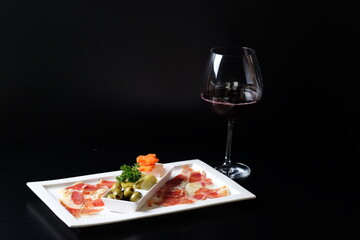 Elegant presentation of delicious food with a glass of red wine. Savor the gourmet appetizer paired with wine