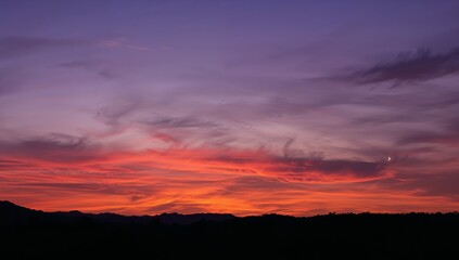 Crimson Sky. A Landscape in Twilight with Subtle Crescents of Light and Shadow.