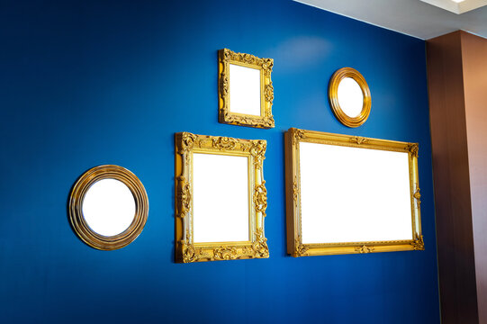 Golden picture frames on blue wall