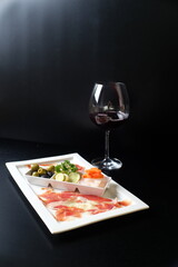 Elegant gourmet appetizers and red wine in a sophisticated dining setting
