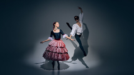 Dance of contrast. Two ballet performers creating visual balance in stage light. Concept of...