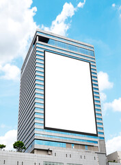 Mock up white vertical large LED display billboard on tower building. Clipping path for mockup