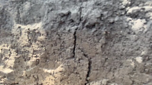 camera moves along shallow trench between dugouts. Opposite the shooting cell there is blue sky and summer meadow with dry grass. War in Ukraine