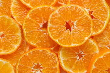 Bright sliced mandarins close-up as background