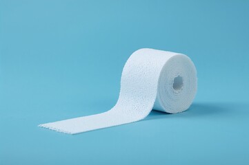Roll of sterile gauze bandage on a blue background