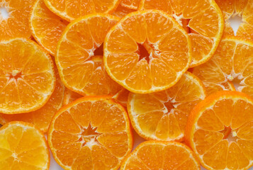 Close-up of sliced mandarins on a plate as background