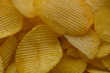 Close-up of potato chips in a plate as background