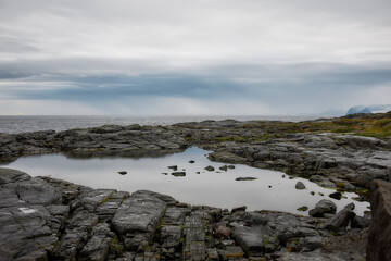 Coastal rocks and water pools after rain, Lofoten islands, Norway