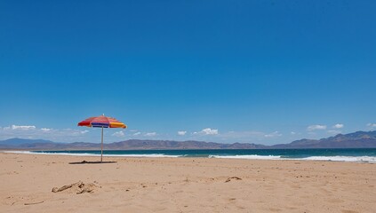Summer sky with blue beach umbrella and sand by the sea