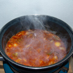 Preparing a hash with onions and stew beef.